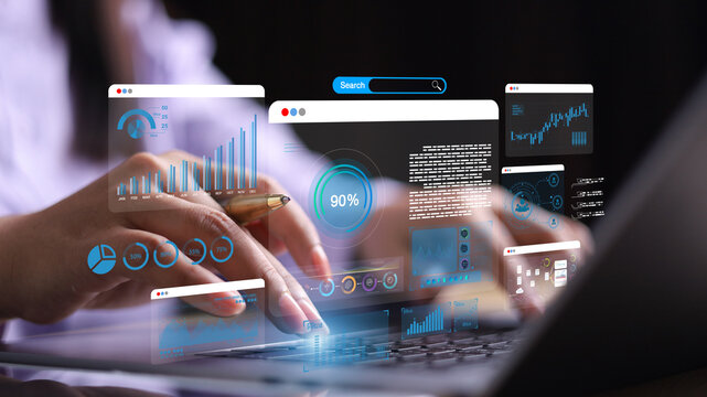 Businesswoman using computer for development and Analytics Data technology management System for report marketing strategy planning. graph analysis and information on a futuristic virtual screen.