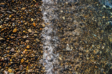 Water sea beach. Wave ocean blue. Stone texture reflection sun. Surface coast pebbles. Abstract light rock background.