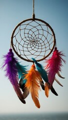 Dreamcatcher with Colorful Feathers Hanging Against Blue Sky
