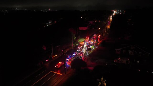 Aerial view of accident scene on road at night. Flashing lights of police, ambulance and fire department. Horror scene on street, frontal crash of cars. Injured and death people. Virginia, USA.
