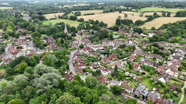 Shere Surrey UK quaint English Village high angle establishing aerial shot
