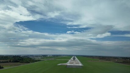 Real time pilot FPV of a landing in a runway surrounded by green fields an a blue sky with some clouds. Immersive pilot’s perspective from cockpit.4K 60FPS