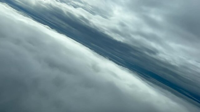 Pilot&rsquo;s POV FPV flying between two layers of clouds. Aerial footage taken from an airplane cockpit. Immersive perspective. 4K 60FPS