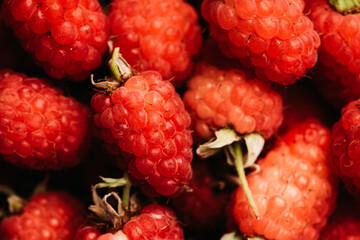 Ripe and juicy raspberry on the dark rustic background. Selective focus. Shot from above.