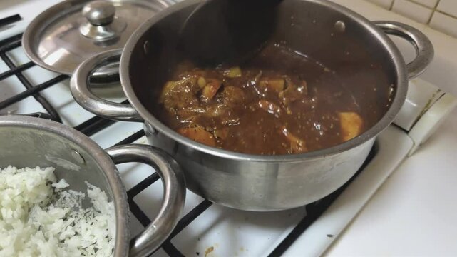 Mexican stew, beef fillets in morita chile sauce and potatoes. Spicy recipe. Boiling on the stove