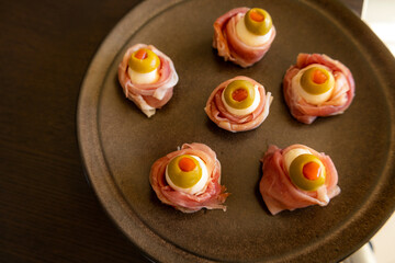 Spooky Halloween Eyeball Finger Food with Prosciutto, Mozzarella, and Green Olives - Keto Appetizer Close-Up