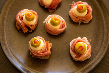 Spooky Halloween Eyeball Finger Food with Prosciutto, Mozzarella, and Green Olives - Keto Appetizer Close-Up