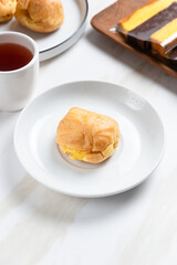 Choux pastry or cream puff. Profiterole. Kue sus. freshly baked. with vanilla cream filling. with copy space. perfect for recipe, article, catalogue, or any commercial purposes.