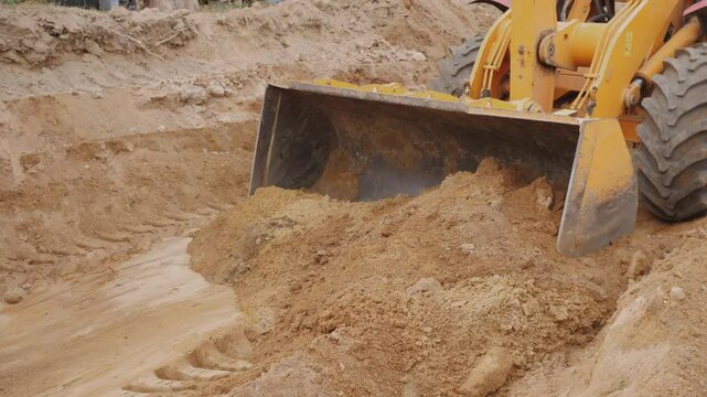 Loader and sand on a construction site
