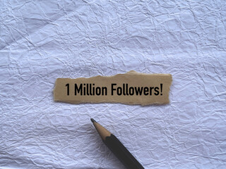 Communication, internet and social media concept. 1 Million Followers written on a ripped papers.