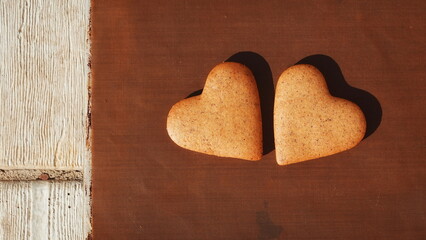 Obraz premium Cookies Heart-Shaped Top View Warm Brown Background
