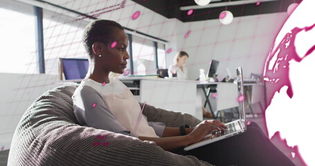 Image of financial data processing over african american businesswoman using laptop