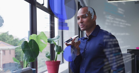 Image of financial data processing over biracial businessman using smartphone in office