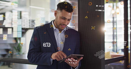 Image of financial data processing over biracial businessman using tablet in office