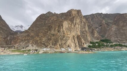 Profile view of Attabad Lake with rugged hills at background in Hunza, Pakistan.