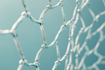 Delicate mesh of intertwined fibers against a soft blue backdrop capturing the essence of structure and light