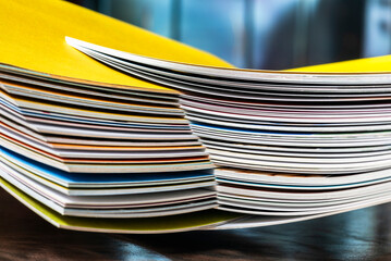 Stack of colored paper arranged in an overlapping pattern with a muted background