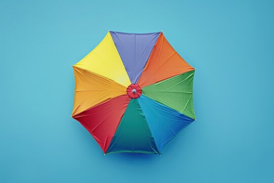 Colorful umbrella against a bright blue background during a sunny day in the park