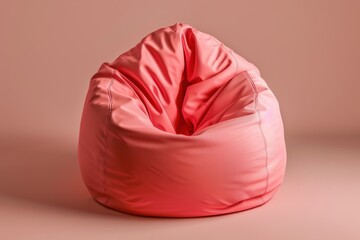 A cozy coral bean bag chair in a soft pink setting, inviting relaxation and comfort for lounging or reading at home