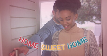 Image of home sweet home text with light spots over diverse couple walking through door