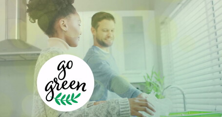 Image of go green text and light spots over diverse couple sorting plastic bottles
