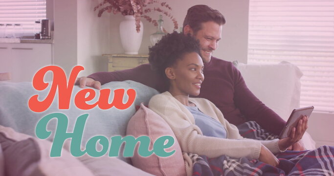 Image of new home text over diverse couple using tablet on sofa