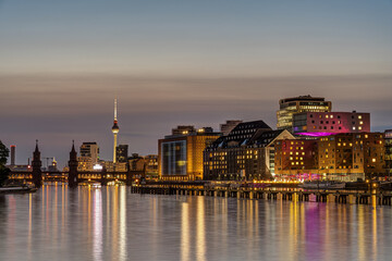 The Oberbaum bridge and the TV Tower in Berlin with the river Spree at twilight