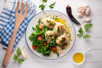Backed Stuffed eggs au gratin with bechamel sauce. Top view table with  decoration.