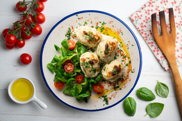 Backed Stuffed eggs au gratin with bechamel sauce. Top view table with  decoration.
