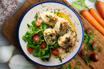 Backed Stuffed eggs au gratin with bechamel sauce. Top view table with  decoration.