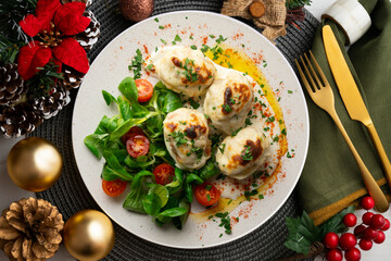 Backed Stuffed eggs au gratin with bechamel sauce. Top view table with Christmas decoration.