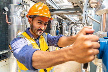 Hands of male technical foreman inspects maintenance turning cut-off valve at plant, Emergency,...