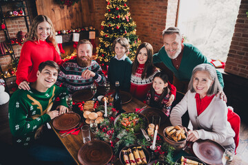 Portrait of friendly peaceful family sit table embrace gather celebrate new year xmas flat indoors