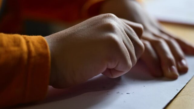 Schoolboy using rubber eraser while doing homework, 4K