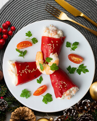 Red piquillo peppers stuffed with cod. Top view table with Christmas decoration.
