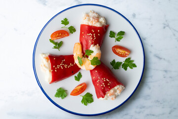 Red piquillo peppers stuffed with cod. Top view table with  decoration.