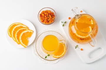Sea buckthorn tea drink with oranges and mint. Autumn comfort hot drink. Herbal vitamin tea. 