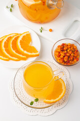 Sea buckthorn tea drink with oranges and mint. Autumn comfort hot drink. Herbal vitamin tea. 