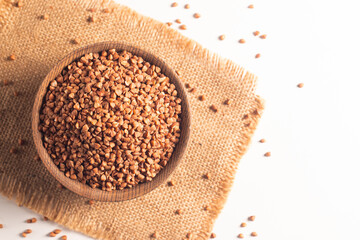 Buckwheat groats on wooden background. Healthy cereal concept