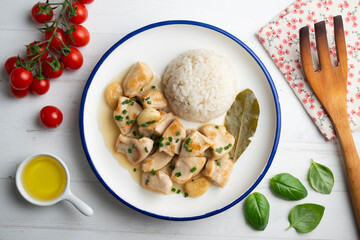 Garlic chicken with bay leaf aroma and white rice. Top view table with  decoration.