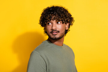 Obraz premium Photo of latin guy with stubble curly hairstyle dressed khaki shirt look at discount empty space isolated on yellow color background