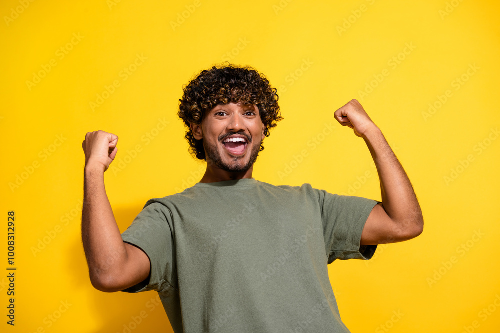 Canvas Prints Photo of ecstatic guy with wavy hair dressed khaki t-shirt scream yeah raising fists up win lottery isolated on yellow color background