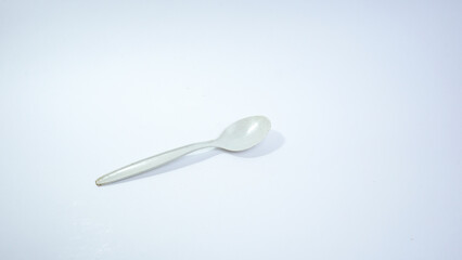 White Plastic Spoon on White Background