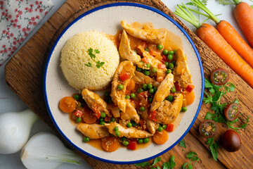 Sautéed chicken strips with vegetables and tomato sauce. Top view table with  decoration.