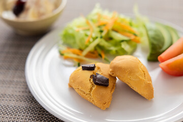 白い皿に乗せられたスコーンとサラダ