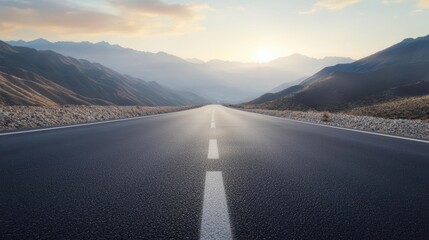 A scenic view of an empty road stretching into the horizon against a backdrop of mountains at sunrise.