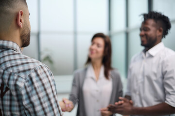 Business people standing and shaking hands in an office building