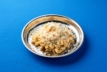 Truffle Mac and Cheese creamy macaroni served in steel plate isolated on blue background side view of italian food