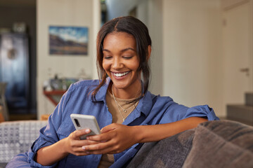 Beautiful multiethnic woman using phone at home