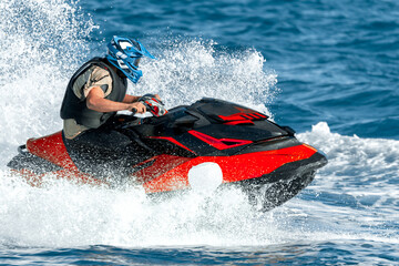 Pilot riding powerful watercraft at high speed on the ocean waves
